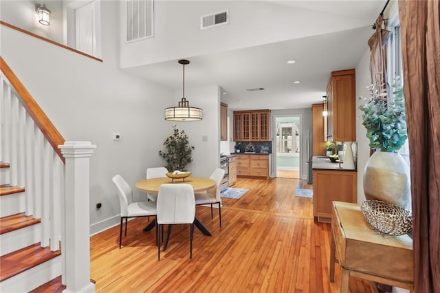 918 Harmony St, New Orleans, LA 70115 - dining room featuring stairs, light wood-style floors, baseboards, and recessed lighting