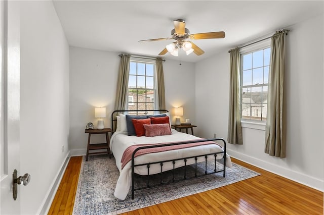 918 Harmony St, New Orleans, LA 70115 - bedroom featuring hardwood / wood-style floors, baseboards, and ceiling fan