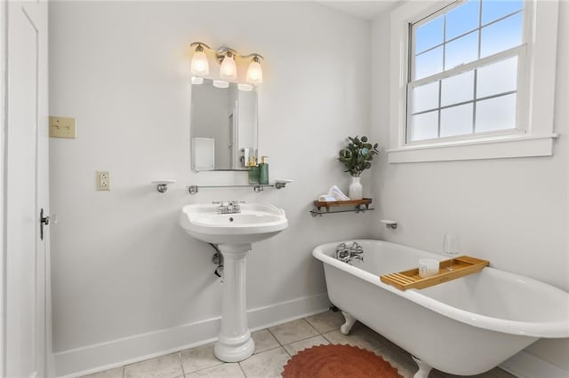 918 Harmony St, New Orleans, LA 70115 - full bathroom with baseboards, a freestanding tub, and tile patterned floors