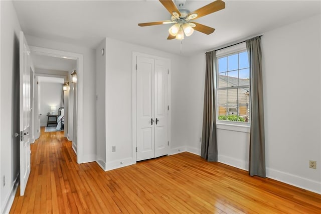 918 Harmony St, New Orleans, LA 70115 - unfurnished bedroom featuring light wood-style floors, baseboards, a closet, and ceiling fan