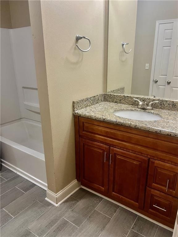1362 Brightside Ln Unit 201, Baton Rouge, LA 70820 - full bath featuring vanity, wood tiled floors, shower / bathtub combination, and baseboards