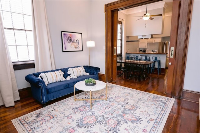 1438-40 Marais St, New Orleans, LA 70116 - living area featuring dark wood-style floors, plenty of natural light, ceiling fan, ornamental molding, and baseboards