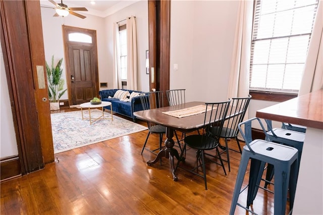 1438-40 Marais St, New Orleans, LA 70116 - dining room featuring wood finished floors, crown molding, and a ceiling fan