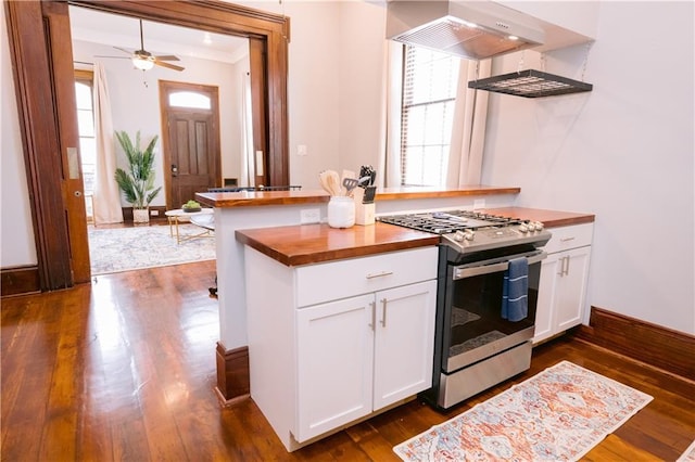 1438-40 Marais St, New Orleans, LA 70116 - kitchen with stainless steel gas stove, butcher block counters, ventilation hood, healthy amount of natural light, and ornamental molding