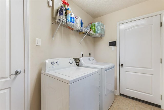 113 Kasey St, Slidell, LA 70458 - washroom with washer and clothes dryer, light tile patterned floors, and a textured ceiling
