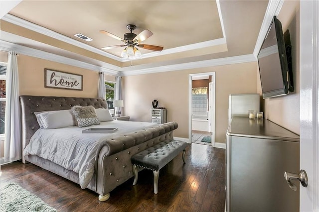 113 Kasey St, Slidell, LA 70458 - bedroom featuring a tray ceiling, dark wood-style flooring, ornamental molding, ensuite bathroom, and baseboards