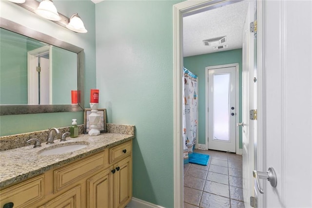 113 Kasey St, Slidell, LA 70458 - bathroom featuring vanity, baseboards, a textured ceiling, and a shower with shower curtain