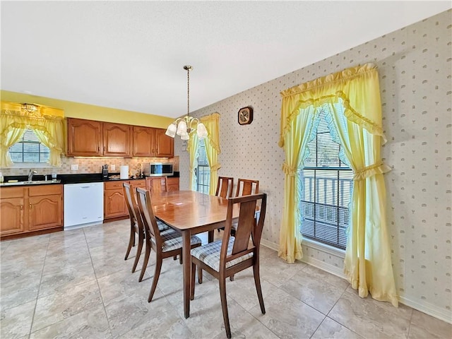 20 Sunset Ln, Carriere, MS 39426 - dining area with wallpapered walls, a chandelier, and baseboards