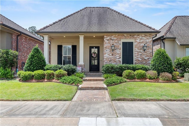 789 Rue St Germain St, Covington, LA 70433 - view of front of home featuring a front yard, stucco siding, and a tile roof