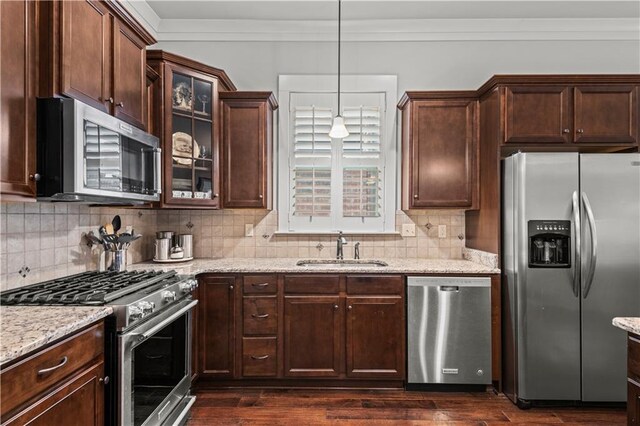 789 Rue St Germain St, Covington, LA 70433 - kitchen featuring stainless steel appliances, a sink, light stone counters, backsplash, and ornamental molding