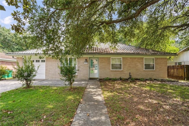 611 Dale Dr, Slidell, LA 70458 - ranch-style home featuring a garage, brick siding, a tile roof, and driveway