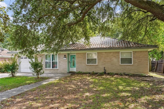 611 Dale Dr, Slidell, LA 70458 - ranch-style house featuring a tiled roof, an attached garage, and brick siding