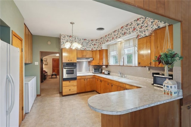 11 Gelbke Dr, Gretna, LA 70053 - kitchen with oven, a sink, light countertops, tasteful backsplash, and under cabinet range hood