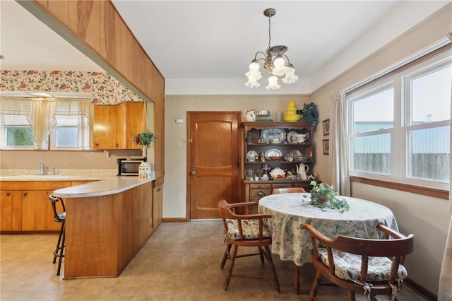 11 Gelbke Dr, Gretna, LA 70053 - dining room featuring a chandelier and baseboards