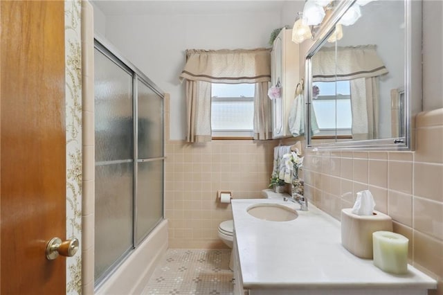 11 Gelbke Dr, Gretna, LA 70053 - full bathroom featuring tile walls, toilet, vanity, tile patterned flooring, and enclosed tub / shower combo