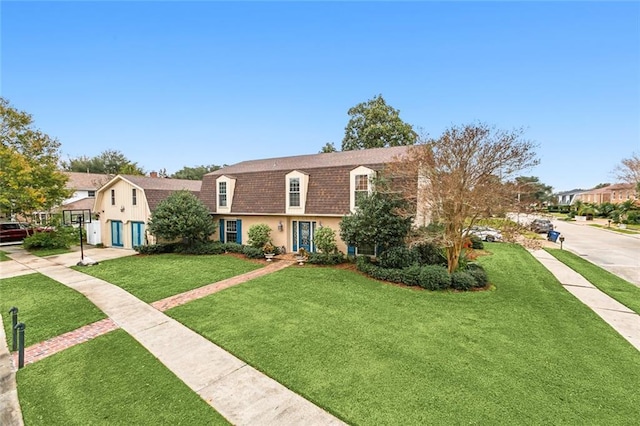 4525 Beau Lac Ln, Metairie, LA 70002 - colonial inspired home with a front lawn and roof with shingles