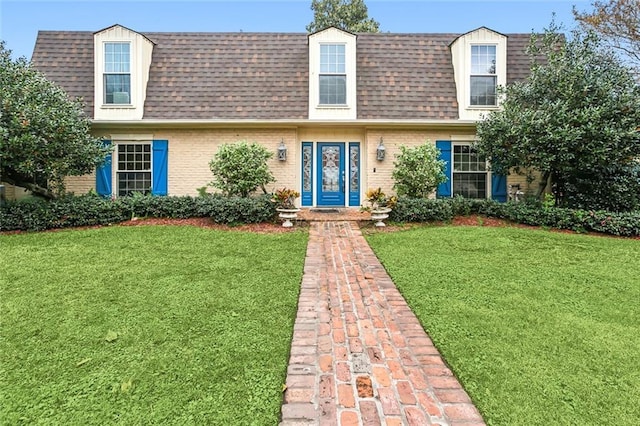 4525 Beau Lac Ln, Metairie, LA 70002 - view of front of home with roof with shingles, a front yard, brick siding, and mansard roof