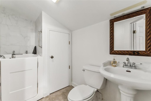 4525 Beau Lac Ln, Metairie, LA 70002 - bathroom featuring lofted ceiling and tile patterned flooring