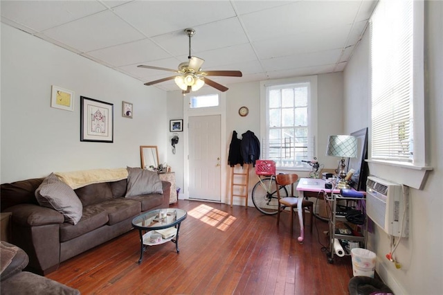 232830 Frenchmen St, New Orleans, LA 70119 - living area with a ceiling fan, an AC wall unit, wood-type flooring, and a paneled ceiling