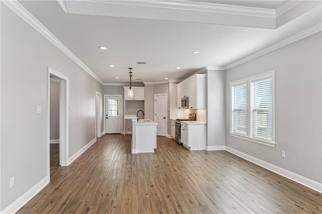 220 Trudeau Dr, Metairie, LA 70003 - kitchen with stainless steel appliances, a sink, wood finished floors, white cabinets, and recessed lighting