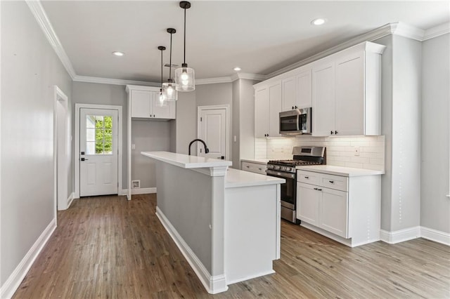 220 Trudeau Dr, Metairie, LA 70003 - kitchen with appliances with stainless steel finishes, backsplash, light countertops, baseboards, and ornamental molding