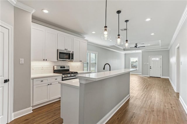 220 Trudeau Dr, Metairie, LA 70003 - kitchen featuring stainless steel appliances, crown molding, tasteful backsplash, ceiling fan, and light countertops