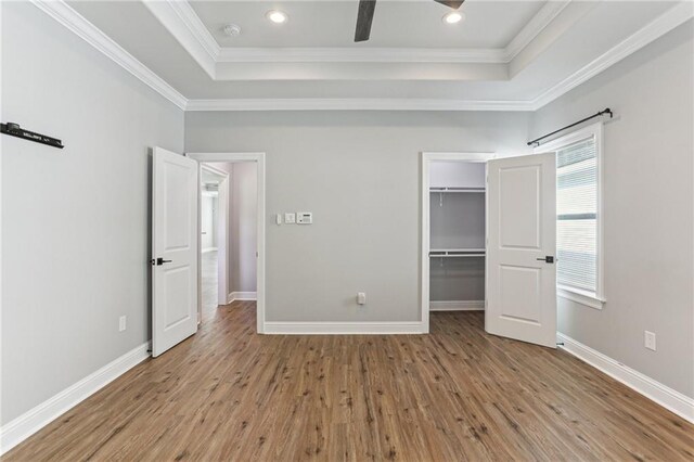 220 Trudeau Dr, Metairie, LA 70003 - unfurnished bedroom with a tray ceiling, wood finished floors, ornamental molding, baseboards, and recessed lighting