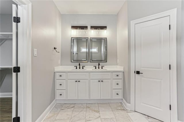 220 Trudeau Dr, Metairie, LA 70003 - full bathroom with double vanity, marble look tile flooring, and baseboards