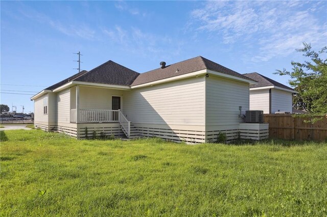220 Trudeau Dr, Metairie, LA 70003 - rear view of property with central AC unit and roof with shingles