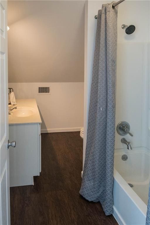 28230 Stanga Rd, Ponchatoula, LA 70454 - bathroom with wood finished floors, vanity, shower / bath combo, and baseboards