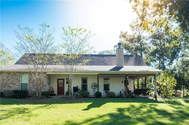 28230 Stanga Rd, Ponchatoula, LA 70454 - view of front of home with a front yard, a chimney, and brick siding