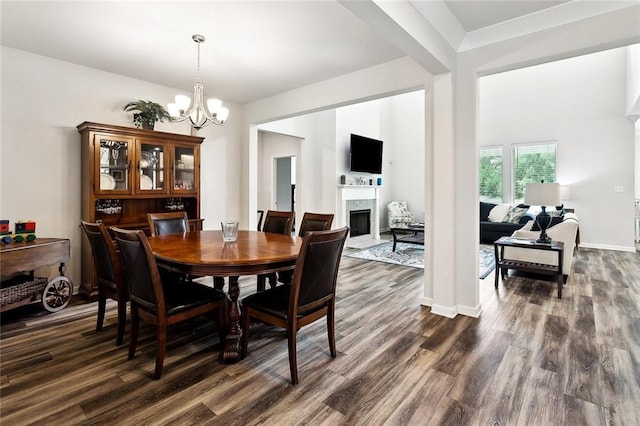 40315 Cypress Reserve Blvd, Ponchatoula, LA 70454 - dining area with a chandelier, a fireplace, dark wood-style floors, and baseboards