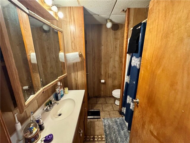 149 Becky Dr, Avondale, LA 70094 - full bath featuring vanity, wooden walls, tile patterned flooring, toilet, and a shower with shower door
