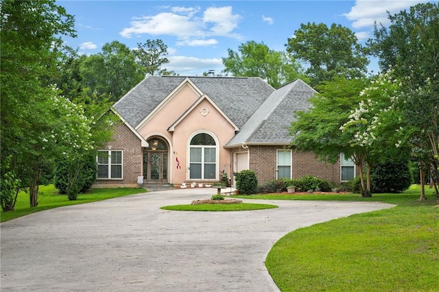 47261 Eldridge Magee Rd, Franklinton, LA 70438 - view of front of property with curved driveway, a front lawn, roof with shingles, brick siding, and a garage