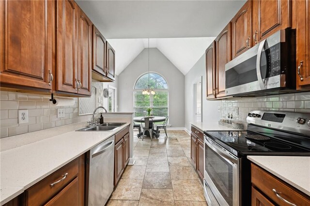 47261 Eldridge Magee Rd, Franklinton, LA 70438 - kitchen with stainless steel appliances, a sink, lofted ceiling, baseboards, and pendant lighting