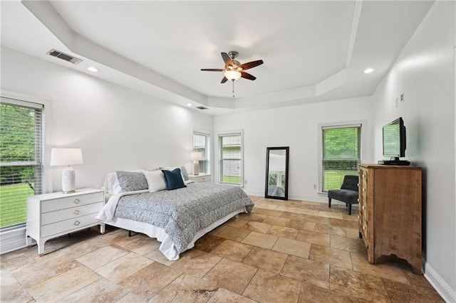 47261 Eldridge Magee Rd, Franklinton, LA 70438 - bedroom featuring a raised ceiling, baseboards, light stone finish floors, recessed lighting, and a ceiling fan