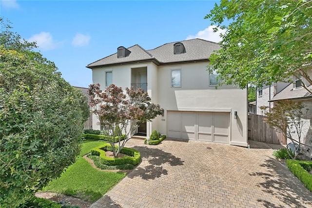 109 Northline St, Metairie, LA 70005 - view of front facade with stucco siding, decorative driveway, and a garage