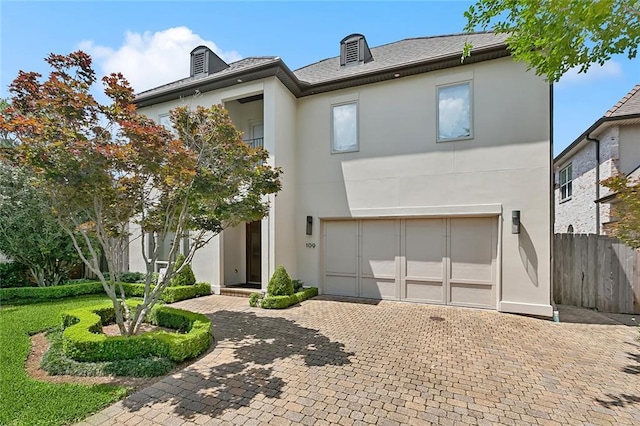 109 Northline St, Metairie, LA 70005 - view of front of house with stucco siding, decorative driveway, and an attached garage