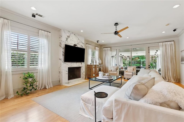 109 Northline St, Metairie, LA 70005 - living area with a premium fireplace, a ceiling fan, ornamental molding, wood finished floors, and recessed lighting