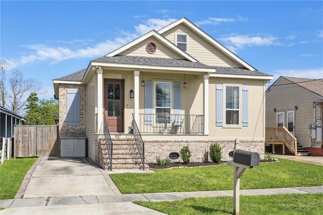5317 Warrington Dr, New Orleans, LA 70122 - bungalow with a shingled roof, brick siding, covered porch, and stucco siding