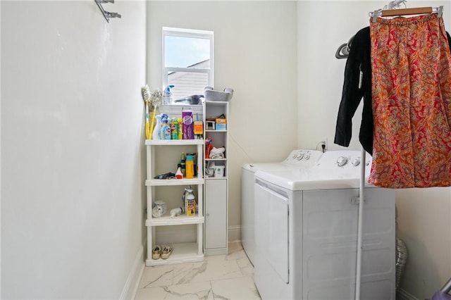 5317 Warrington Dr, New Orleans, LA 70122 - washroom with washing machine and dryer, light marble finish flooring, and baseboards