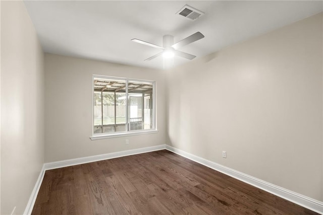 213 Loop Dr, Slidell, LA 70458 - spare room featuring dark wood-style flooring, ceiling fan, and baseboards