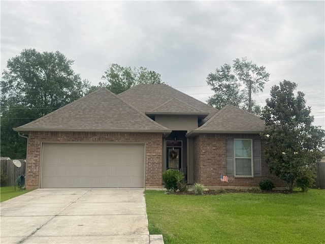 11018 Regency Ave, Hammond, LA 70403 - view of front facade with roof with shingles, concrete driveway, a garage, and a front lawn