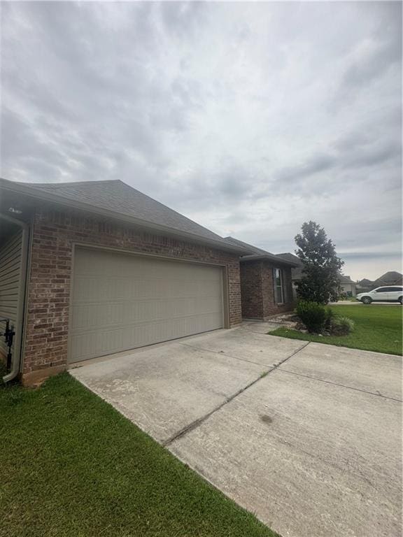 11018 Regency Ave, Hammond, LA 70403 - view of front of house featuring brick siding, concrete driveway, an attached garage, and a front lawn