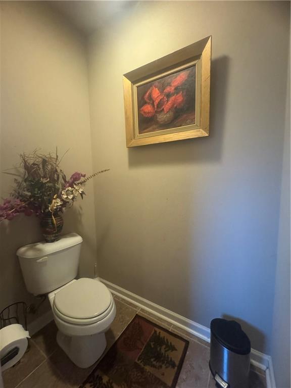 11018 Regency Ave, Hammond, LA 70403 - bathroom with toilet, baseboards, and tile patterned floors