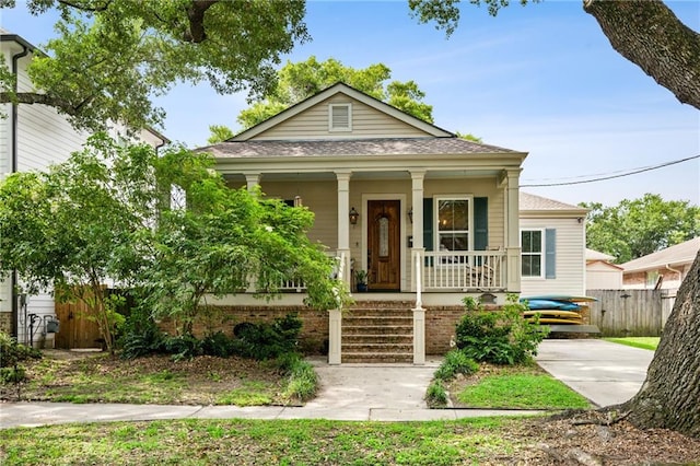 1450 Madrid St, New Orleans, LA 70122 - view of front facade featuring covered porch and roof with shingles