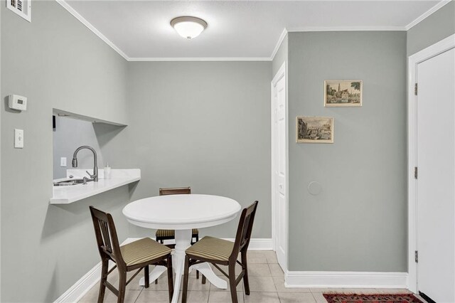 4101 Hessmer Ave Unit 109, Metairie, LA 70002 - dining space with ornamental molding, baseboards, and light tile patterned flooring