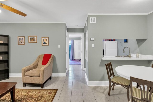 4101 Hessmer Ave Unit 109, Metairie, LA 70002 - tiled living room featuring a sink, crown molding, baseboards, and ceiling fan