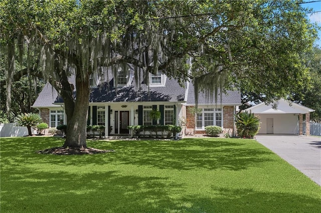 126 Rue Acadian, Belle Chasse, LA 70037 - view of front facade with brick siding, driveway, and a carport