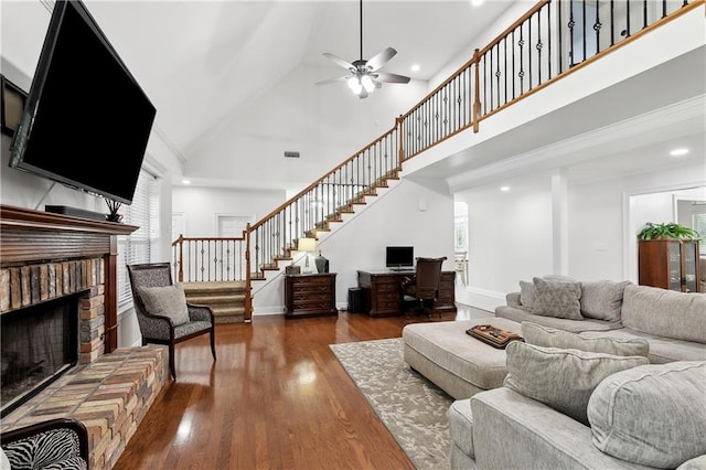126 Rue Acadian, Belle Chasse, LA 70037 - living area with high vaulted ceiling, ceiling fan, stairway, a brick fireplace, and wood finished floors